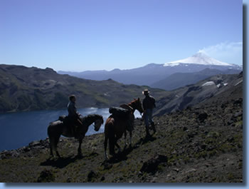 Riders in front of Villarrica, on the Crossing the Andes on Horseback in Northern patagonia Trail